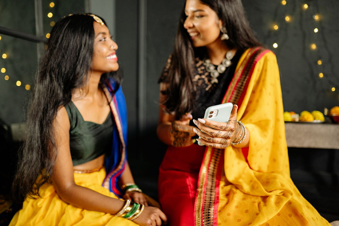 Two friends sharing a phone and recommending products